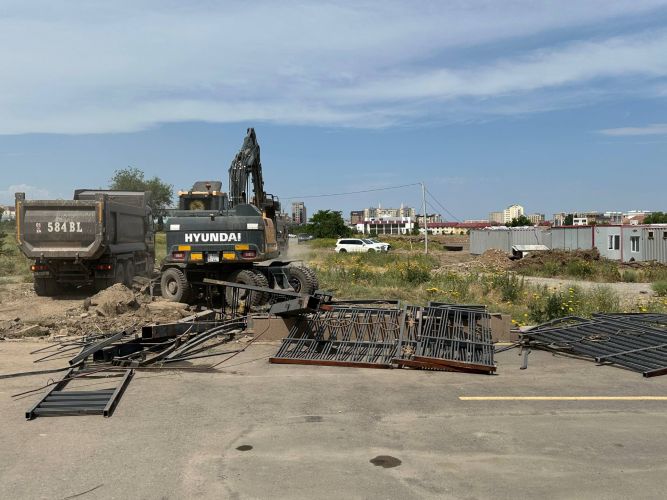 Part of Manas University's campus fencing being dismantled in Bishkek